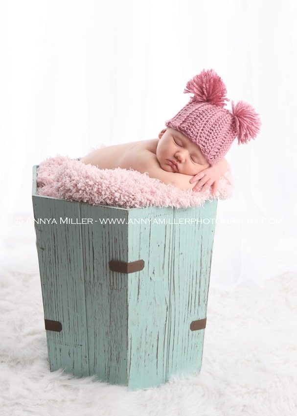 Sweet newborn in basket by Pickering photographer