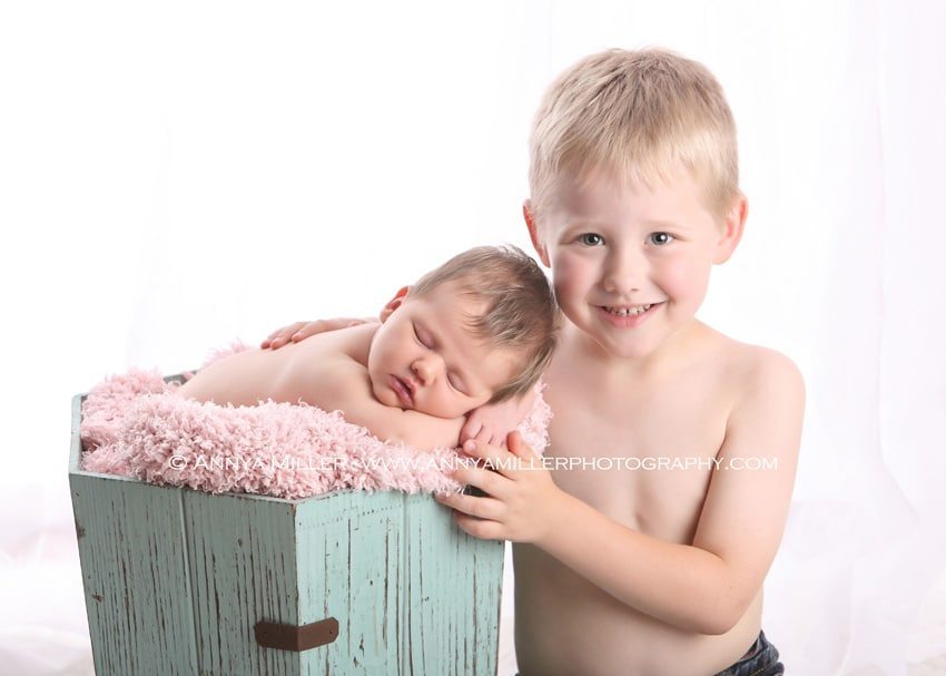 Boy with his newborn baby sister