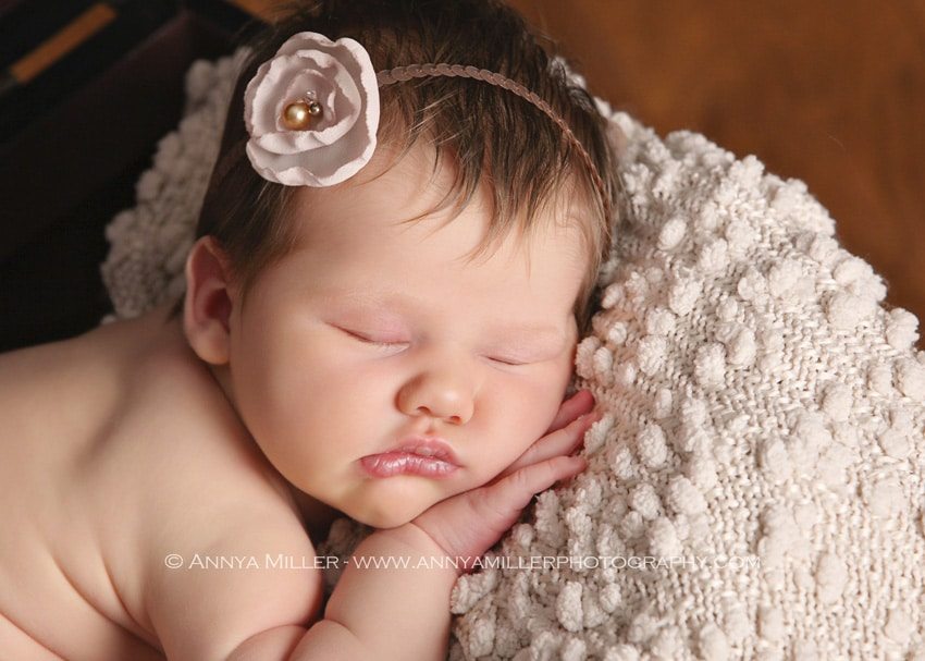 Sweet newborn wearing adorable tie back by baby photographer in Pickering
