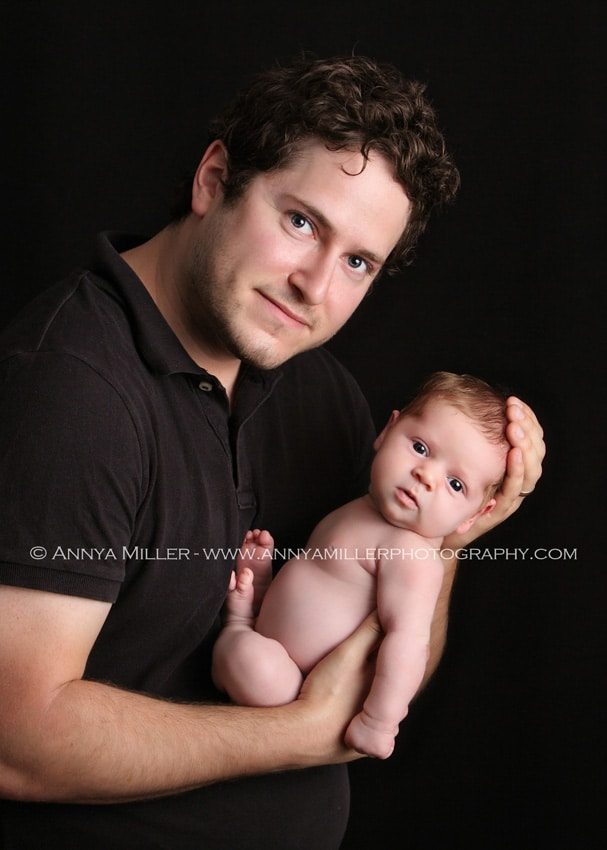 Professional portrait of newborn with her father