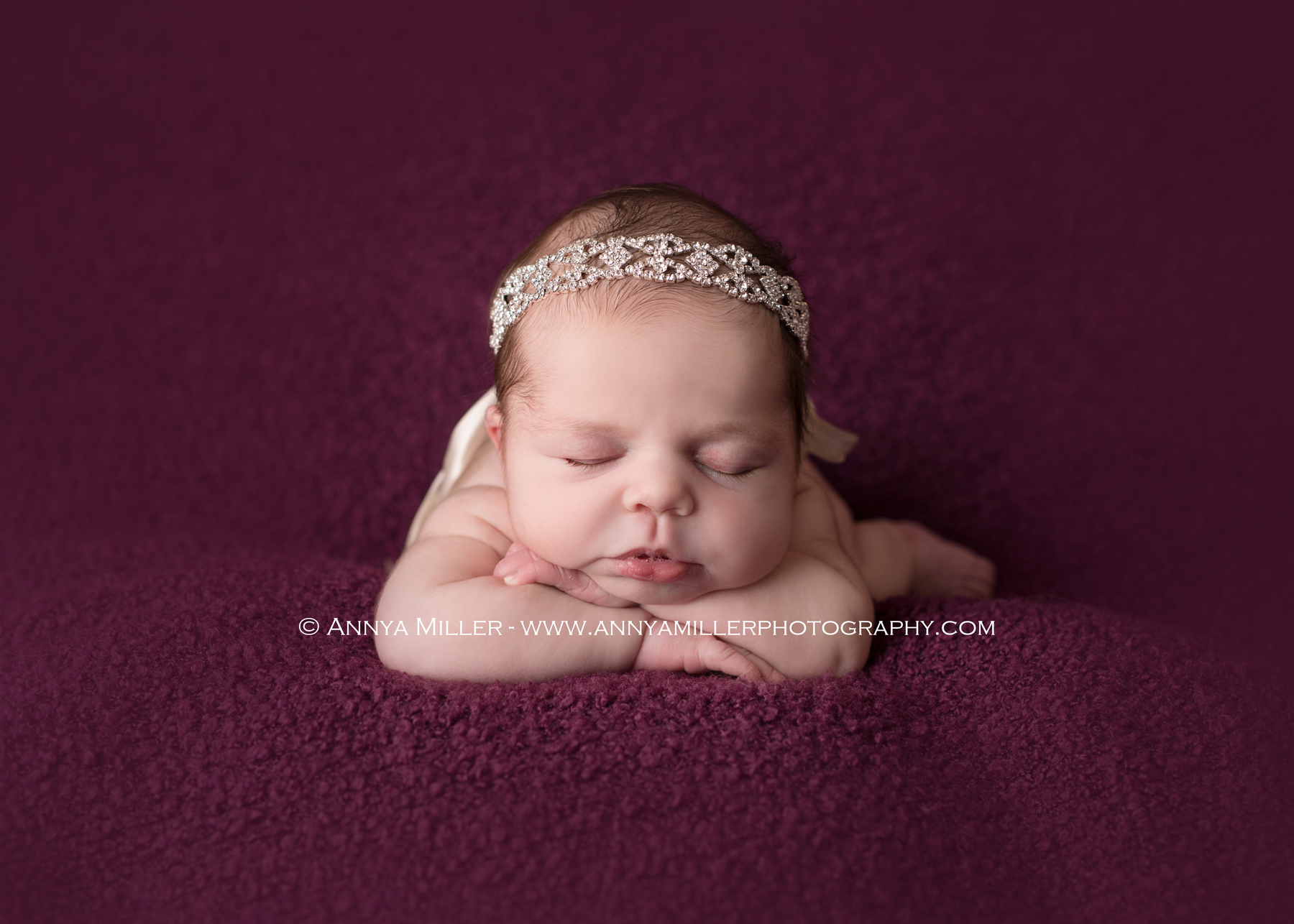 Portrait of newborn girl on purple backdrop by Toronto newborn photographer Annya Miller 