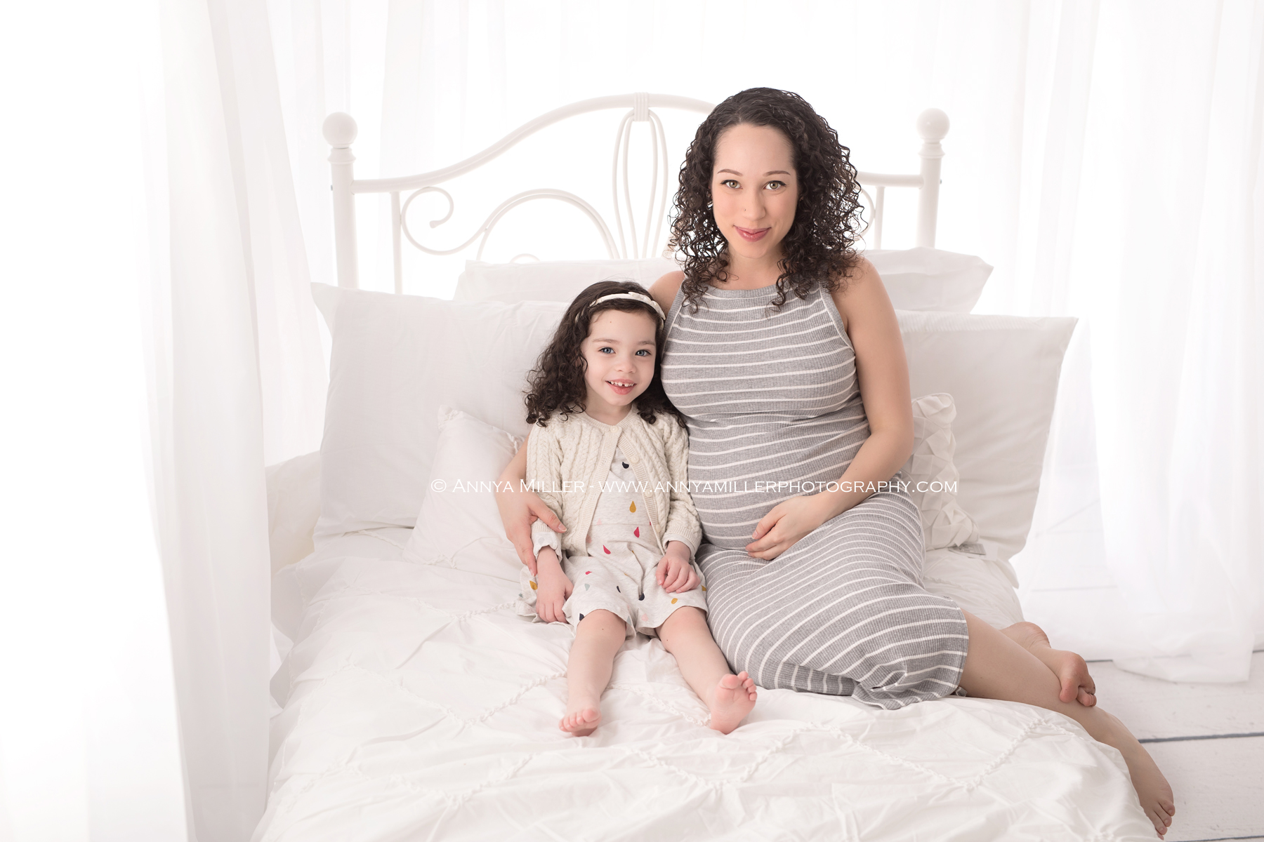 pregnancy portraits on white bed by durham region maternity photographer Annya Miller 