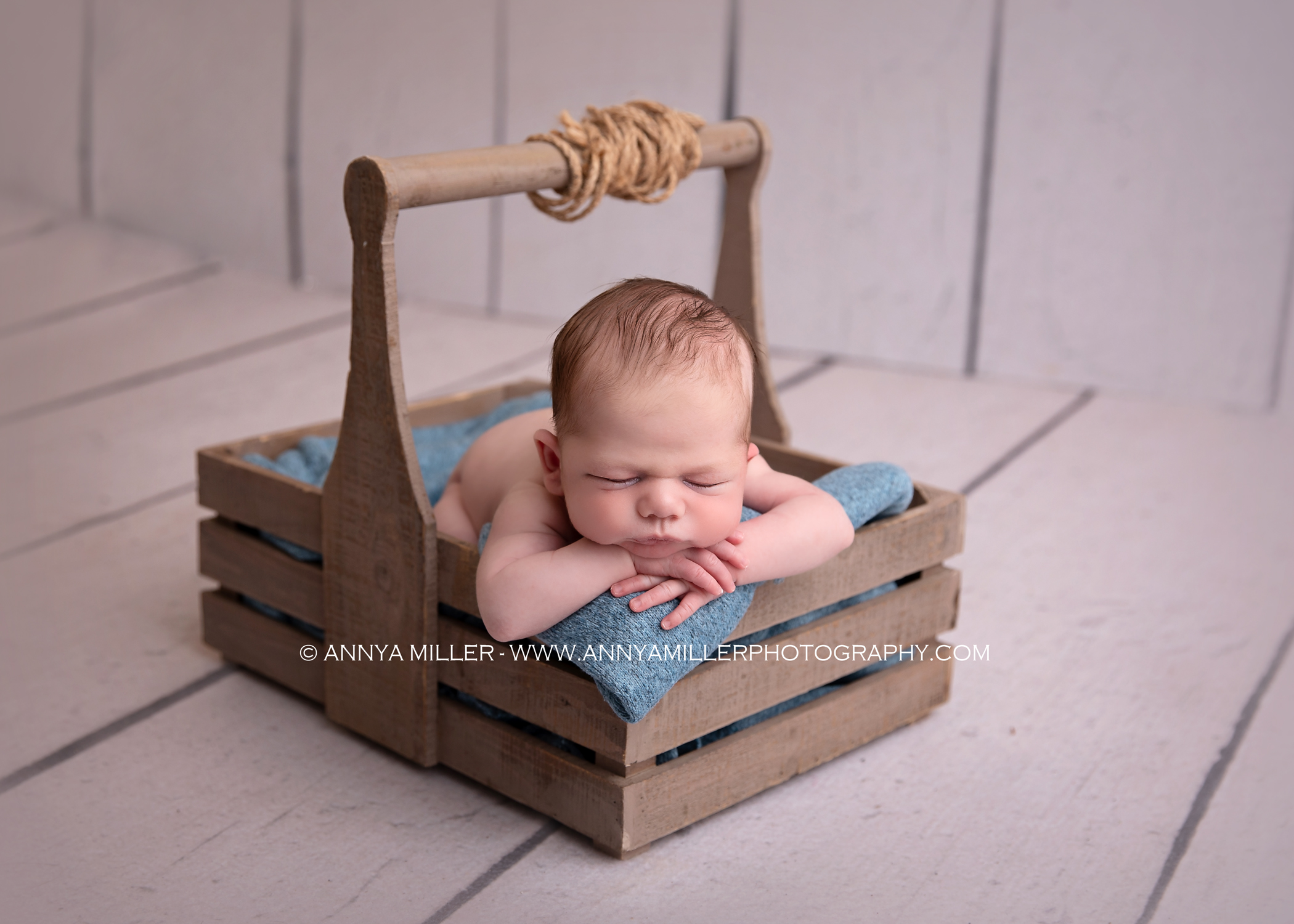 Portraits of baby boy sleeping in rustic crate by ajax newborn photographer Annya miller 