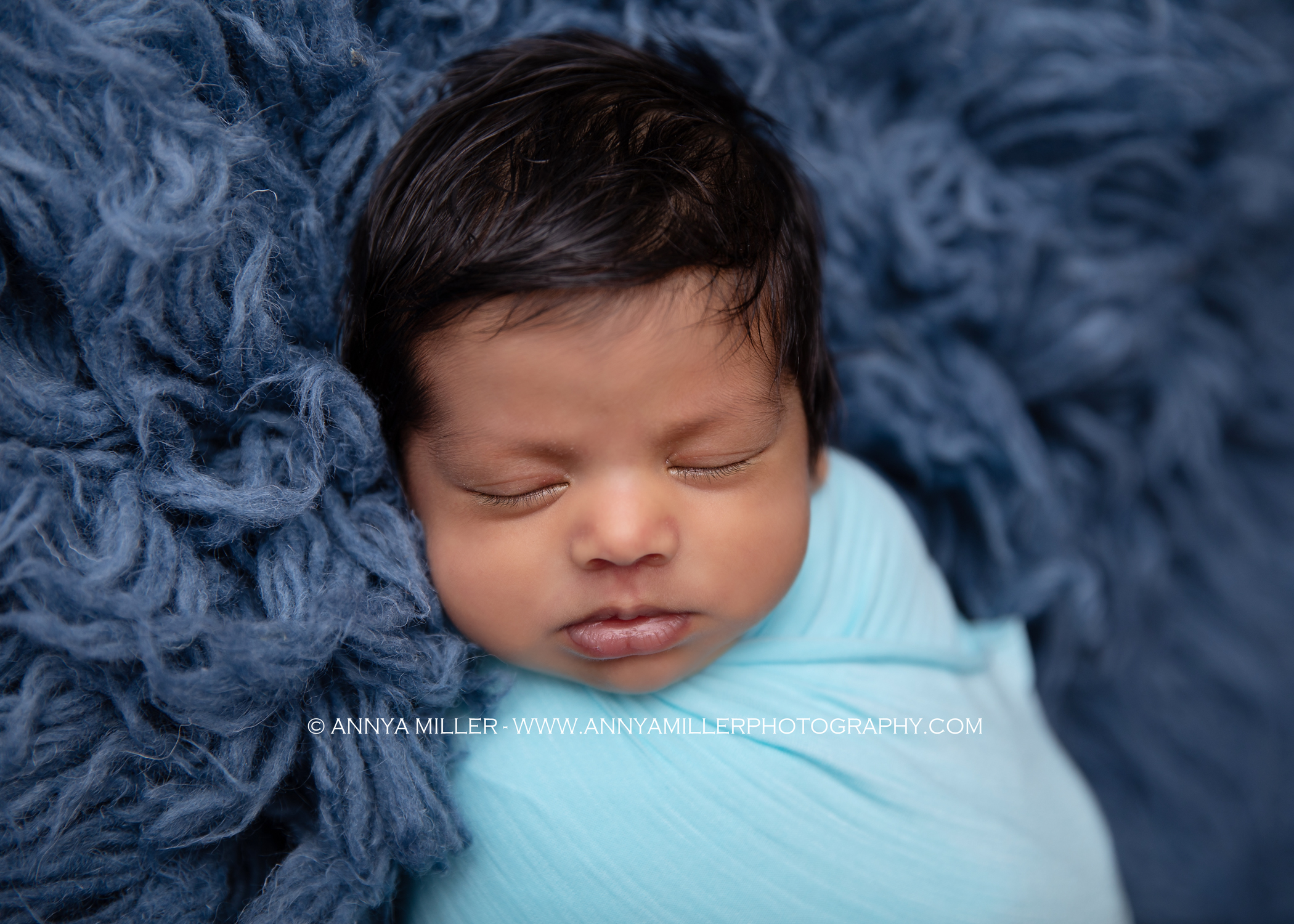 Durham newborn photos of baby boy wrapped in blue by Annya Miller photography