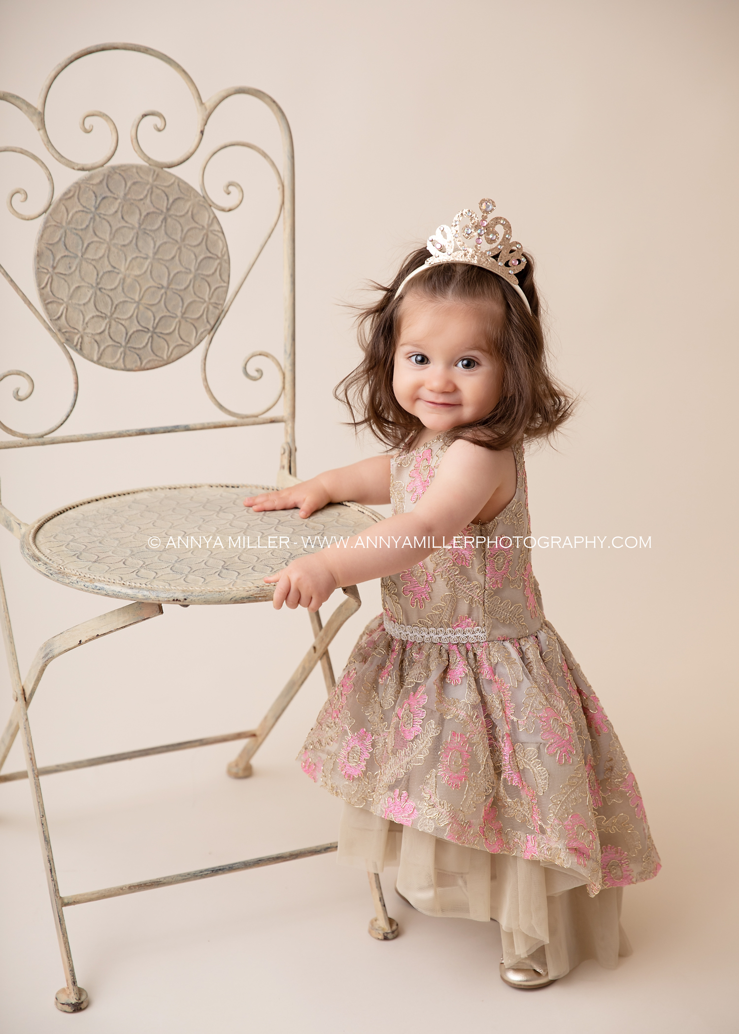 First birthday portraits of baby girl in pink and gold by GTA cake smash photographer Annya Miller 