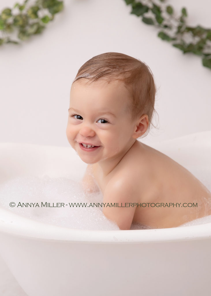 Splash! Baby bubble bath after cake smash sessions by Pickering cake smash photographer Annya Miller