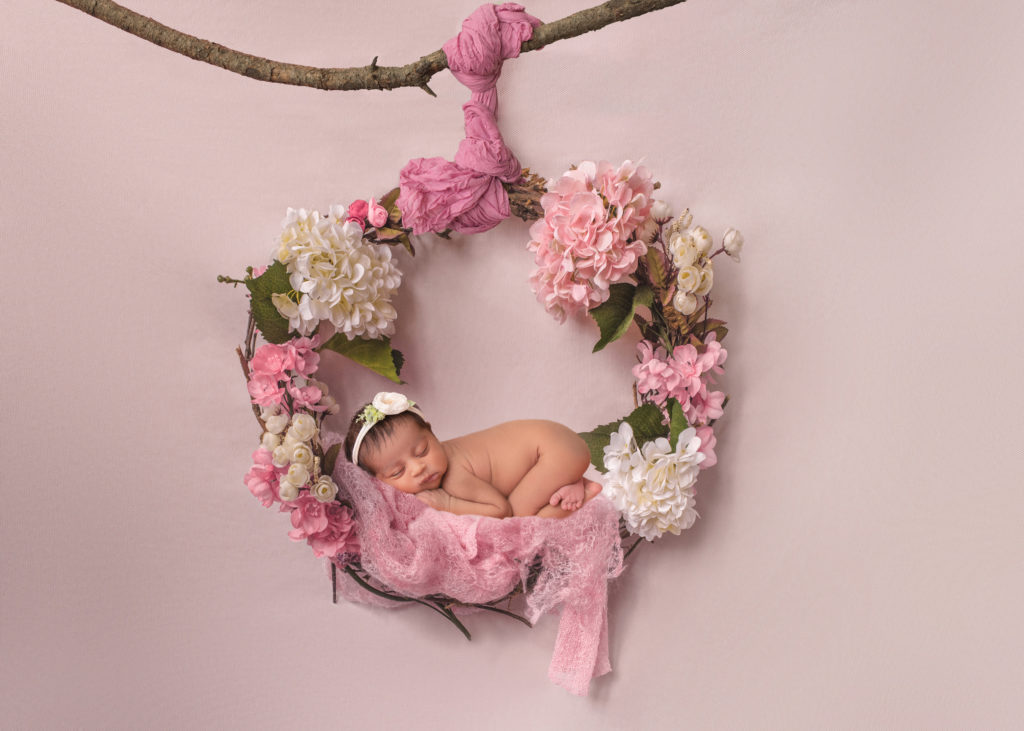 Portrait of newborn baby girl in floral wreath by Durham Region newborn photographer Annya Miller of Pickering