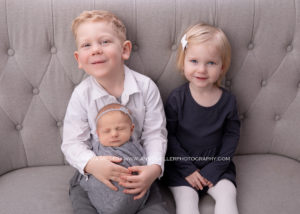 Newborn portrait of baby girl and siblings by Pickering photographer Annya Miller
