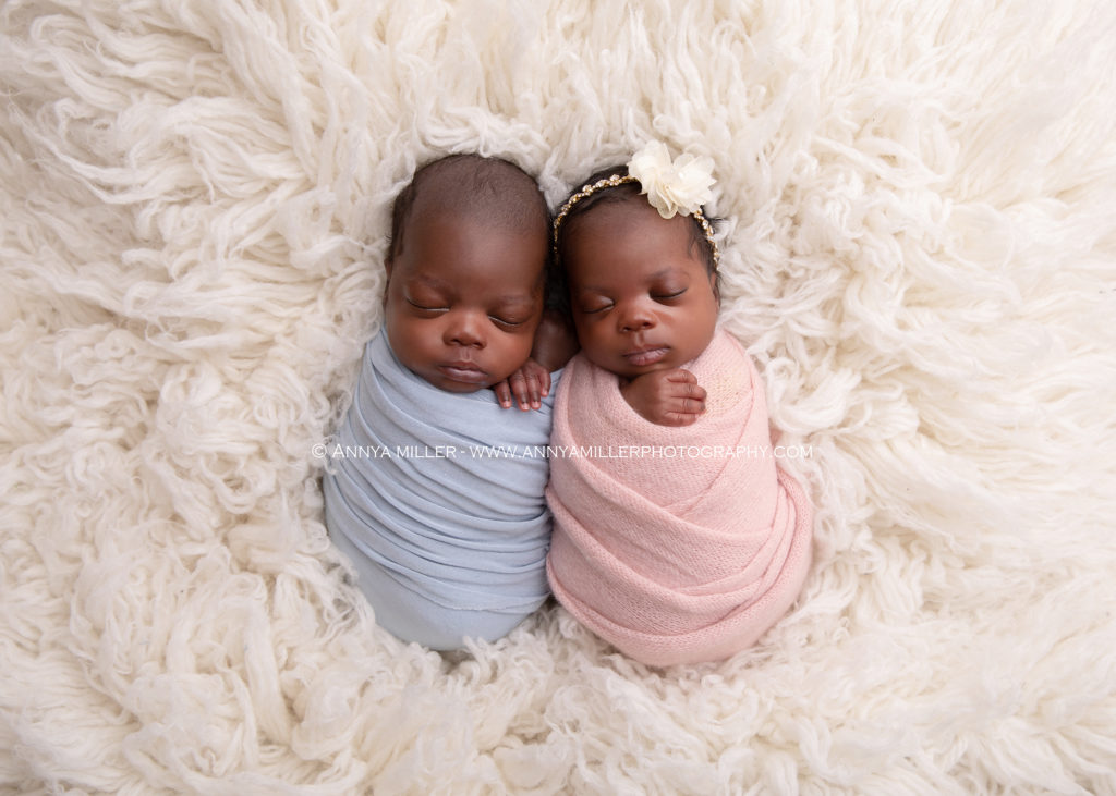 Portrait of new parents with twin babies by Toronto newborn twin photographer Annya Miller